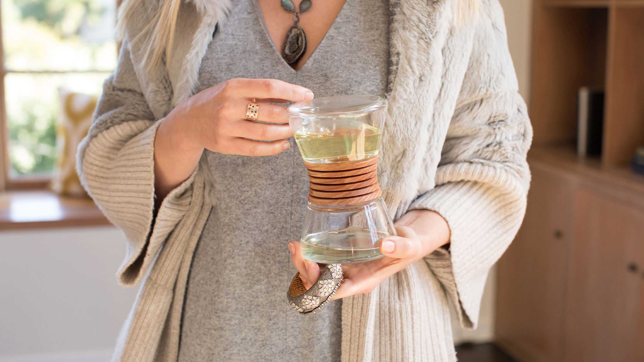 Close up of woman in her living room holding the diffuser in her hands